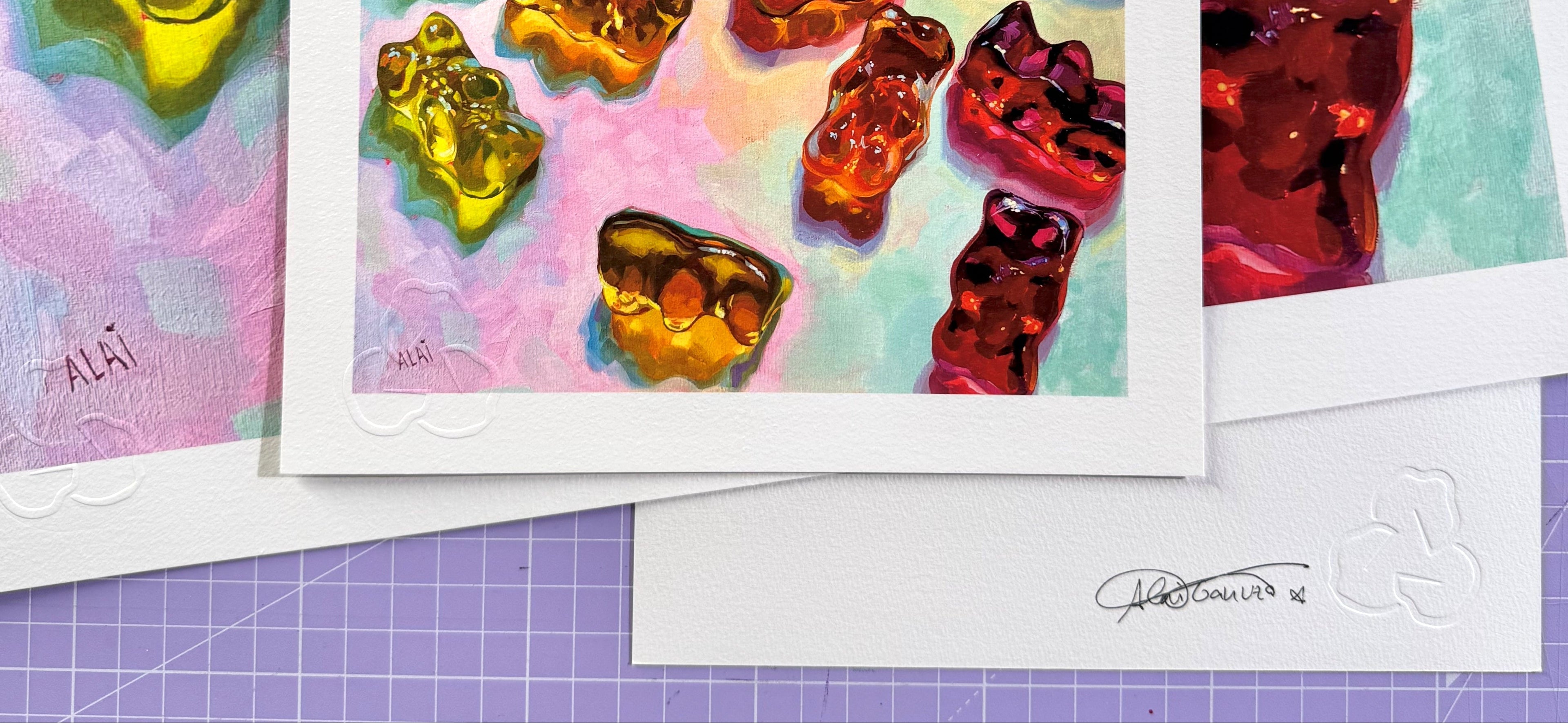 Certified and signed fine art prints by Alai Ganuza featuring colorful gummy bear oil paintings, embossed seal and artist’s signature visible on archival paper.