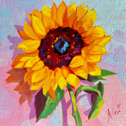 Original oil painting by Alai Ganuza titled "Sunflower". A bright yellow sunflower with a dark center and green leaves painted on a pink and blue pastel background on a square wood panel.