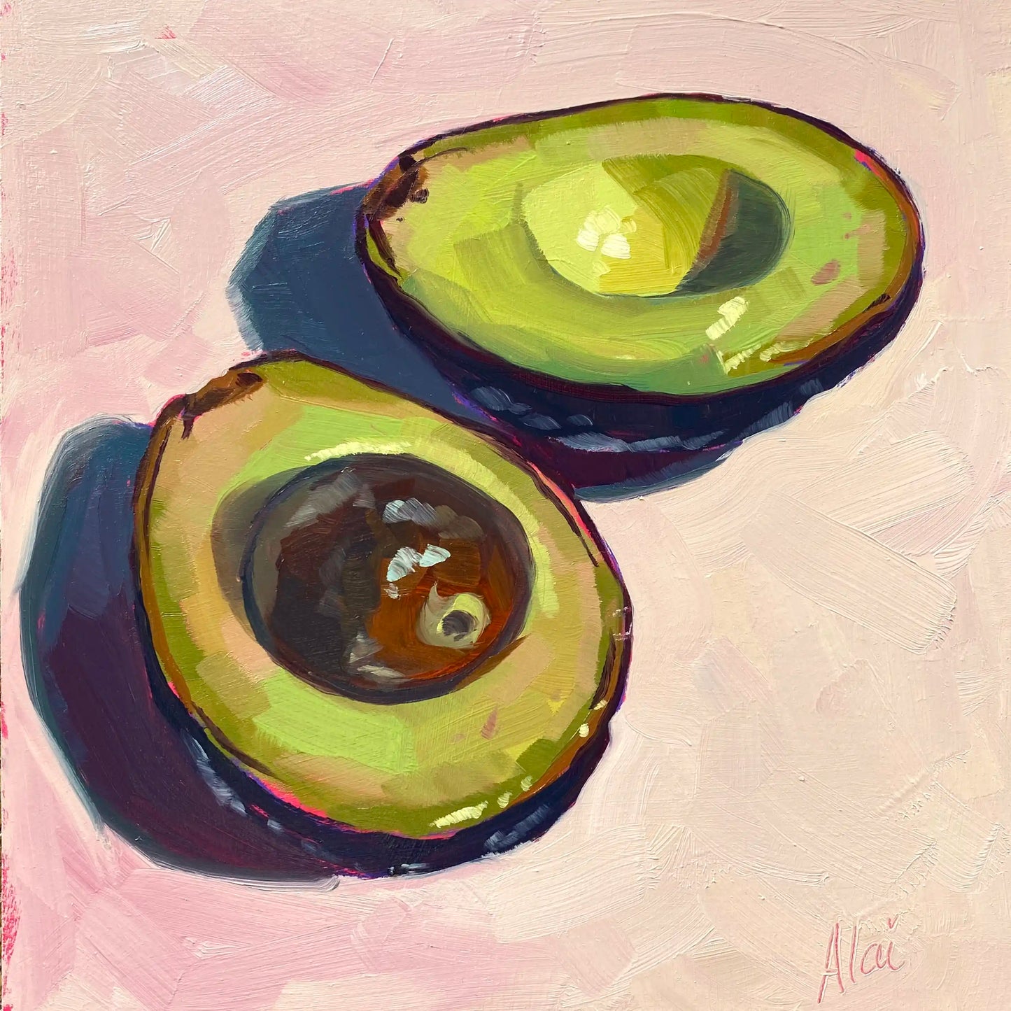 An original oil painting titled Green Vibrations by Alai Ganuza. The still life study depicts two sliced avocado halves, one with a dark brown pit, resting on a soft pink surface. The painting features thick, blocky impasto oil brushstrokes on a textured canvas, with dramatic deep purple and blue shadows casting to the side, signed Alai in pink in the bottom right corner.