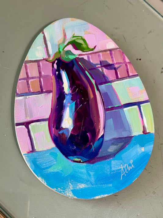 full view of the painting egg-plant. An eggplant painted on an egg-shaped canvas.