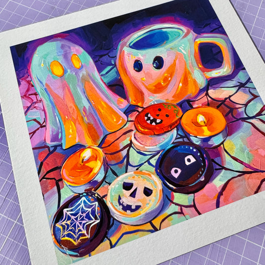 A high-quality physical fine art print on textured white paper showing Ghost Duet and Chocolates, depicting two cute ghost figures, glowing candles, and Halloween chocolates painted in vibrant purple, orange, and turquoise tones.