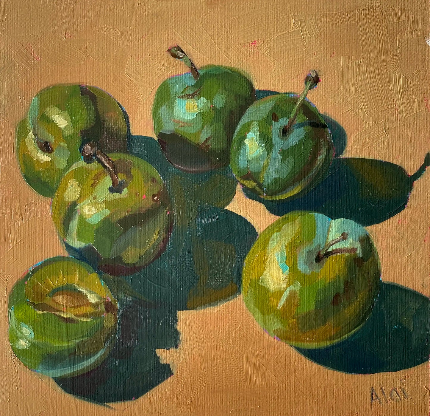 An original oil painting titled Golden Ochre and Plums by Alai Ganuza. It depicts a still life study of six green plums scattered across a warm, solid golden-ochre background. One plum in the lower left corner is sliced open. The artwork features thick, blocky impasto oil brushstrokes on a textured canvas, with dramatic, deep teal geometric shadows casting to the right of each fruit, signed Alai in the bottom right corner.