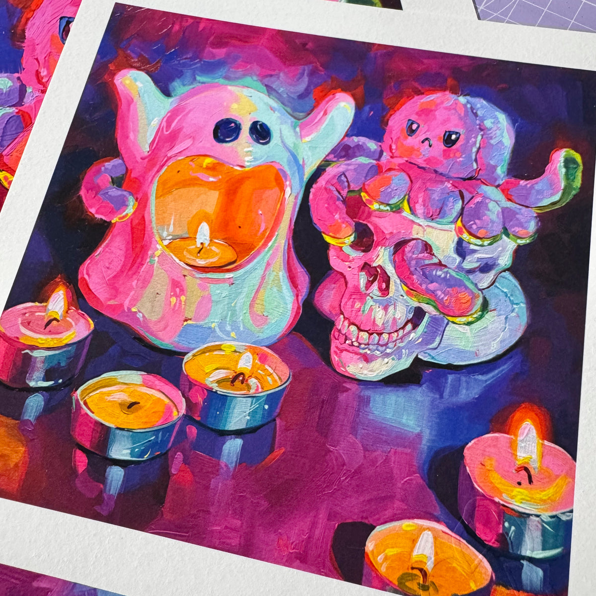 A high-quality physical fine art print on textured white paper showing Possessed, depicting a glowing pink ghost candle holder, tea lights, and a skull topped with a purple toy octopus painted in vibrant magenta and neon tones.