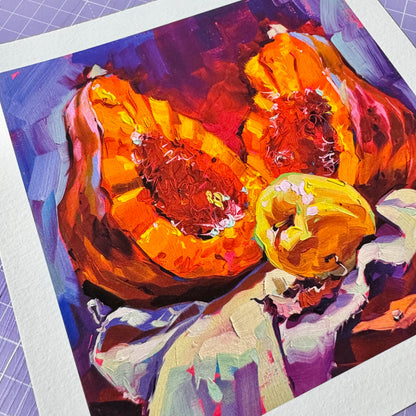 A high-quality physical fine art print on textured white paper showing Pumpkin Still Life, depicting a sliced bright orange pumpkin and a yellow apple painted with bold impasto marks and deep purple shadows.