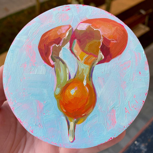 Original oil painting by Alai Ganuza titled "Breaking egg". An egg captured mid-crack with a bright orange yolk falling from two orange shells, rendered in thick impasto on a circular wood panel against a light blue background.