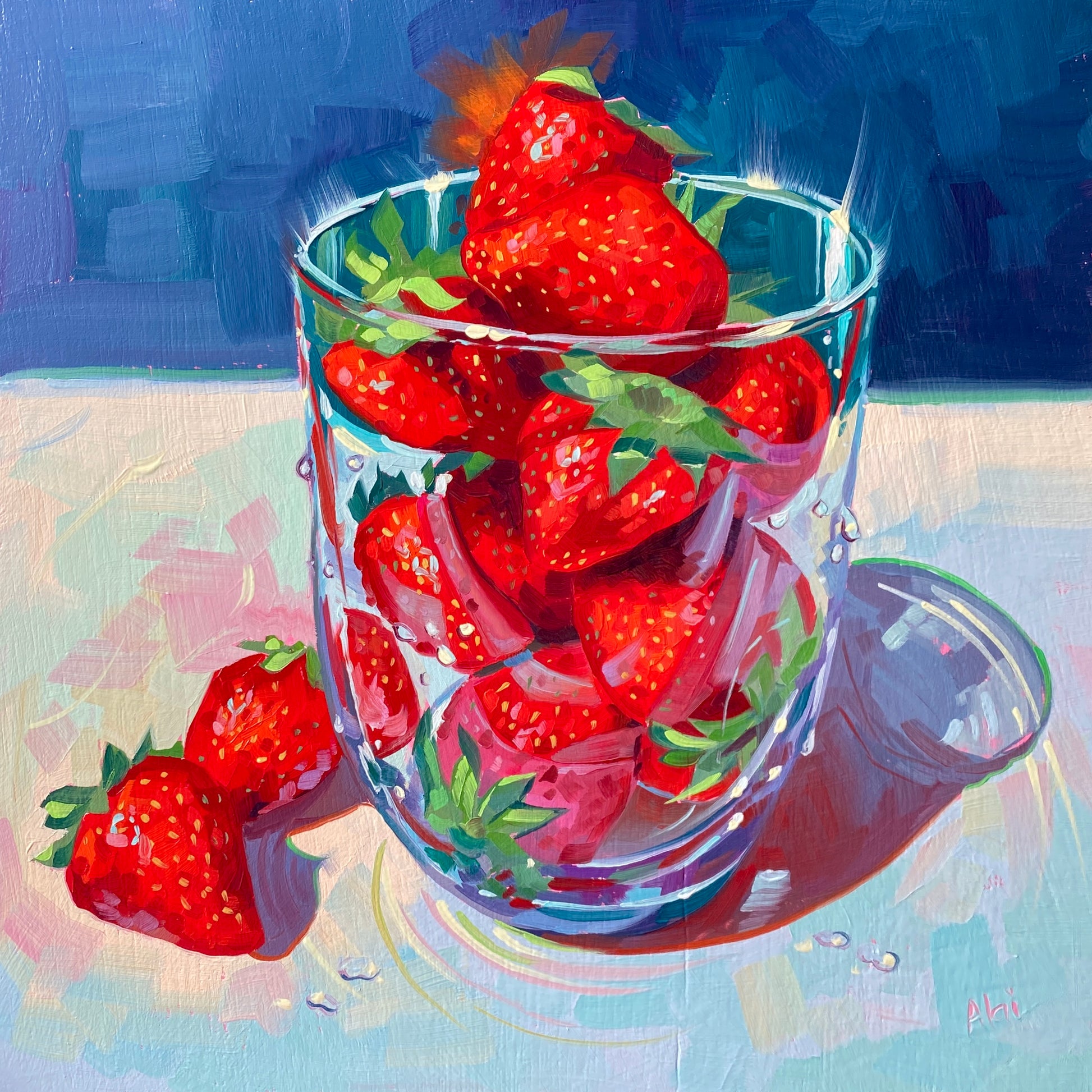 Original oil painting by Alai Ganuza titled "Eau de strawberry". A clear glass tumbler filled with bright red strawberries, with two extra berries resting on a light pastel surface beside it, all set against a deep blue background.