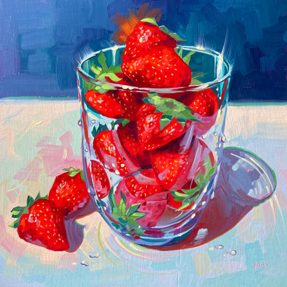 Original oil painting by Alai Ganuza titled "Eau de strawberry". A clear glass tumbler filled with bright red strawberries, with two extra berries resting on a light pastel surface beside it, all set against a deep blue background.