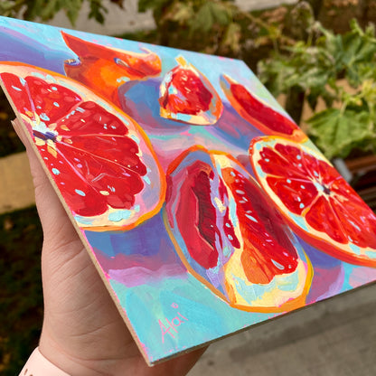 Pomelos sobre pintura al óleo rosa