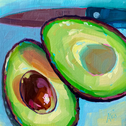 Original oil painting by Alai Ganuza titled "Avocados and knife II". Two ripe avocado halves, one showing a dark pit with pink reflections, set against a bright blue background with a knife blade visible.