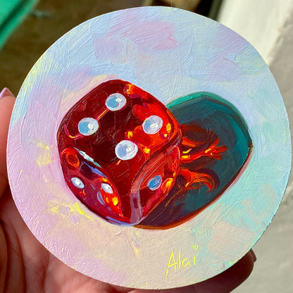 Original circular oil painting by Alai Ganuza titled "Red dice". A translucent red die with white pips casting a deep teal shadow with bright red light refractions on a textured light pastel background.