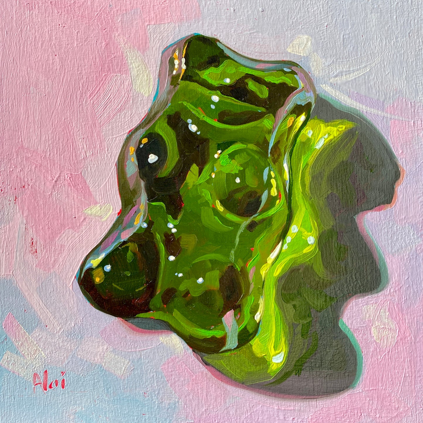 Original oil painting by Alai Ganuza titled "Sweet Life: Green". A large, glossy green gummy bear candy, rendered with translucent textures and bright highlights, on a pastel pink and blue background.