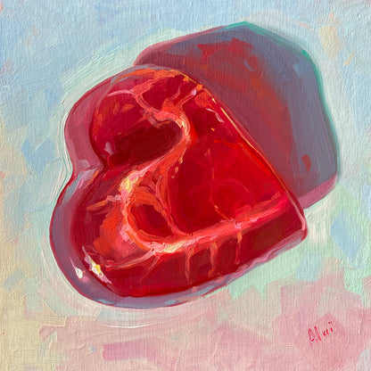 Original oil painting by Alai Ganuza titled "Sweet Life: Heart". A large, glossy red heart-shaped gummy candy, rendered with translucent textures and bright highlights, on a pastel pink and blue background.