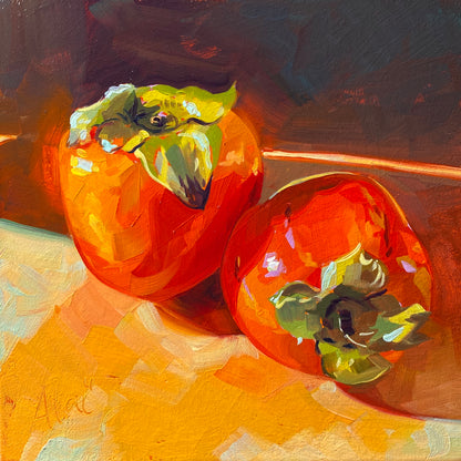 Original oil painting by Alai Ganuza titled "Persimmons (Vibrant)". Two bright orange persimmons with green leafy tops resting on a warm surface, painted with saturated colors on an orange underpainting.