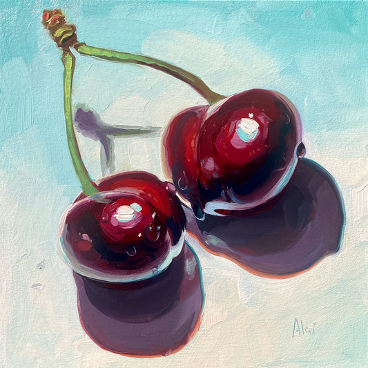 Original oil painting by Alai Ganuza titled "Sexy cherries". Two deep red, glossy cherries with green stems rendered in thick impasto, featuring vibrant teal reflections and casting a deep purple shadow on a light blue background.