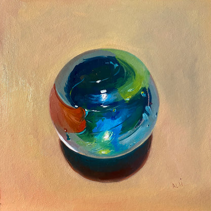 Original oil painting by Alai Ganuza titled "Little big marble". A large glass marble with swirls of deep blue, emerald green, and a splash of orange, rendered in thick impasto with a glowing teal shadow on a warm ochre background.