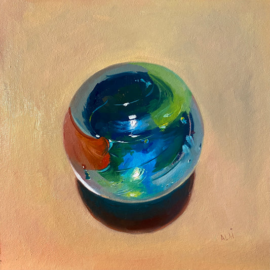 Original oil painting by Alai Ganuza titled "Little big marble". A large glass marble with swirls of deep blue, emerald green, and a splash of orange, rendered in thick impasto with a glowing teal shadow on a warm ochre background.