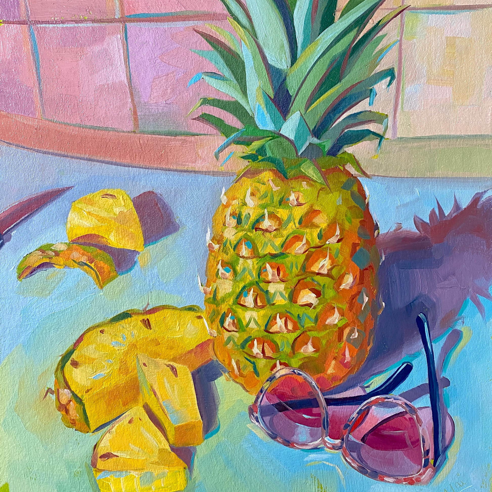 Original oil painting by Alai Ganuza titled "Pineapple and sunglasses". A whole pineapple, several sliced wedges, and pink-rimmed sunglasses rendered in thick impasto on a teal surface against a pink tiled background.