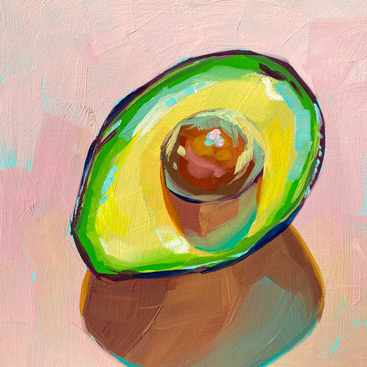 Original oil painting by Alai Ganuza titled "Avocado". A halved avocado with a prominent brown pit, rendered in thick impasto with vibrant lime green, yellow, and electric blue highlights on a pink background.