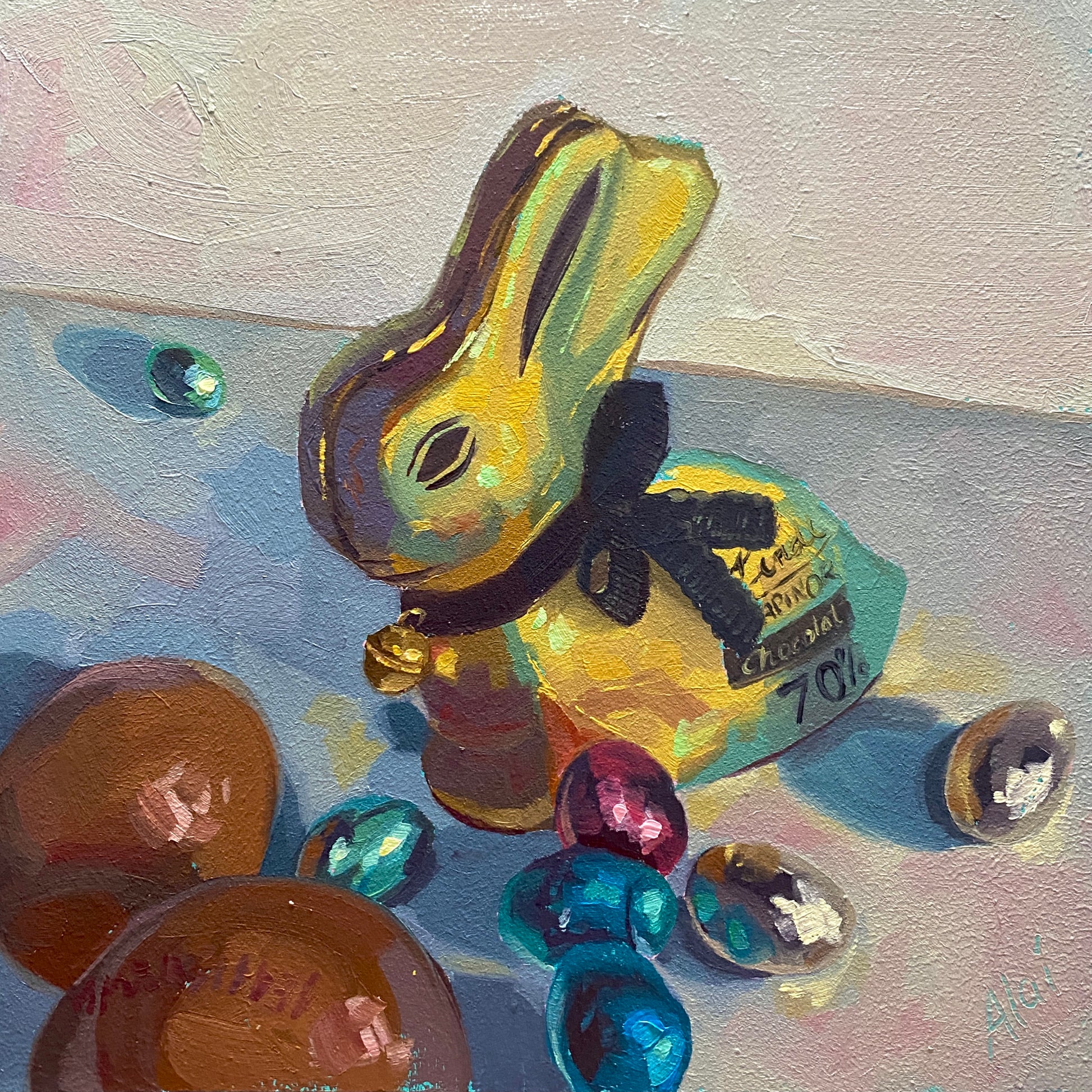 Original oil painting by Alai Ganuza titled "Easter Gold Bunny". A gold foil-wrapped chocolate bunny with a black bow and bell, surrounded by colorful teal and magenta foil eggs, rendered in thick impasto on a textured light background.