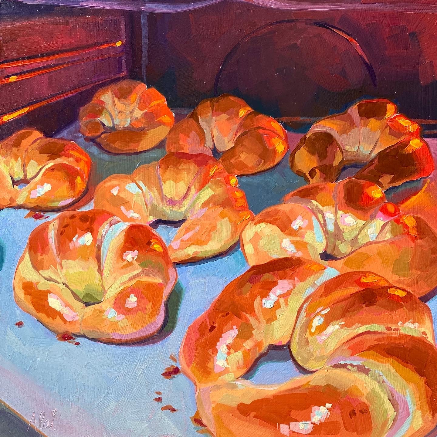 Original oil painting by Alai Ganuza titled "In the oven". A tray of golden-brown croissants baking inside an oven, illuminated by a warm orange glow with cool blue shadows on the baking sheet.
