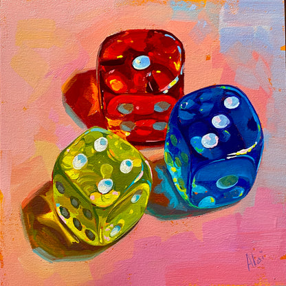 Original oil painting by Alai Ganuza titled "Dice III". Three translucent dice in vibrant red, green, and blue rest on a textured warm pink and peach pastel background, casting colorful, luminous shadows.