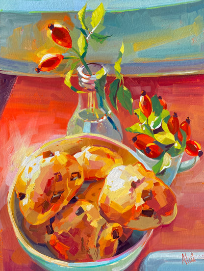 Original oil painting by Alai Ganuza titled "Choco Buns". A bowl of golden chocolate chip buns sits on a warm orange table next to a clear vase and a cup filled with red rose hips and green leaves.