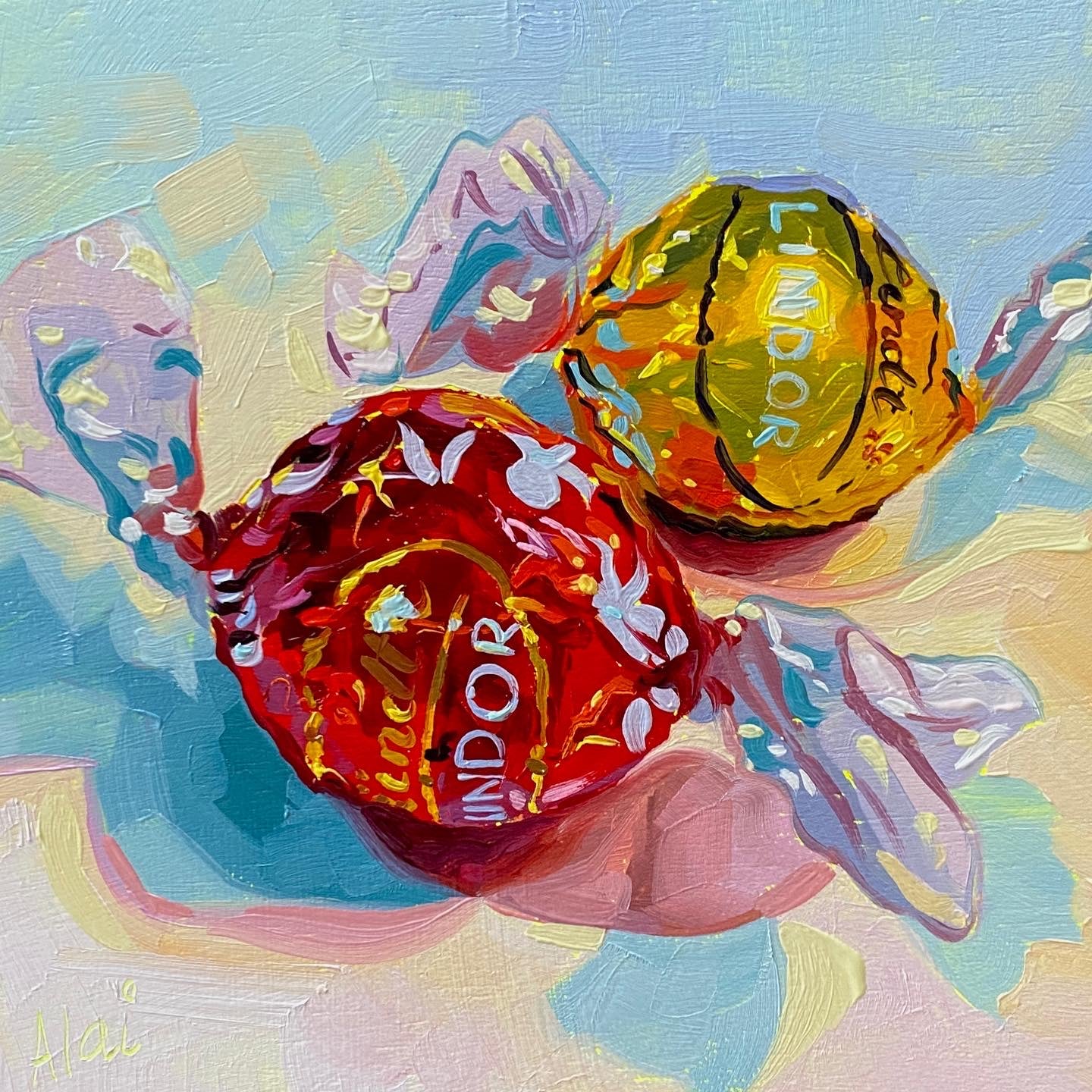 Original oil painting by Alai Ganuza titled "Lindt chocolates III". Two Lindor truffles, one in a red wrapper and one in a yellow wrapper, rendered in thick impasto with cyan and white highlights casting pink and blue shadows.