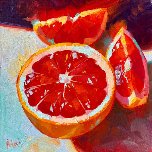 Original oil painting by Alai Ganuza titled "Glowing Grapefruits". A halved ruby red grapefruit and two wedges with glowing, translucent pulp, painted on a light blue surface against a dark background.