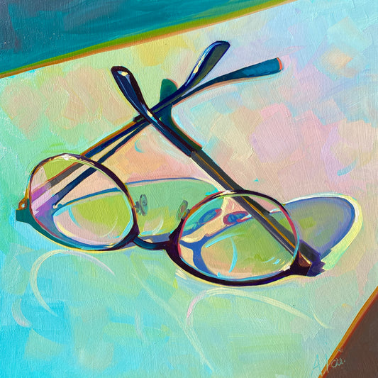 Original oil painting by Alai Ganuza titled "Glasses II". A pair of round-frame glasses rendered in thick impasto with vibrant teal, pink, and lime green reflections, casting a glowing prismatic shadow on a light surface.