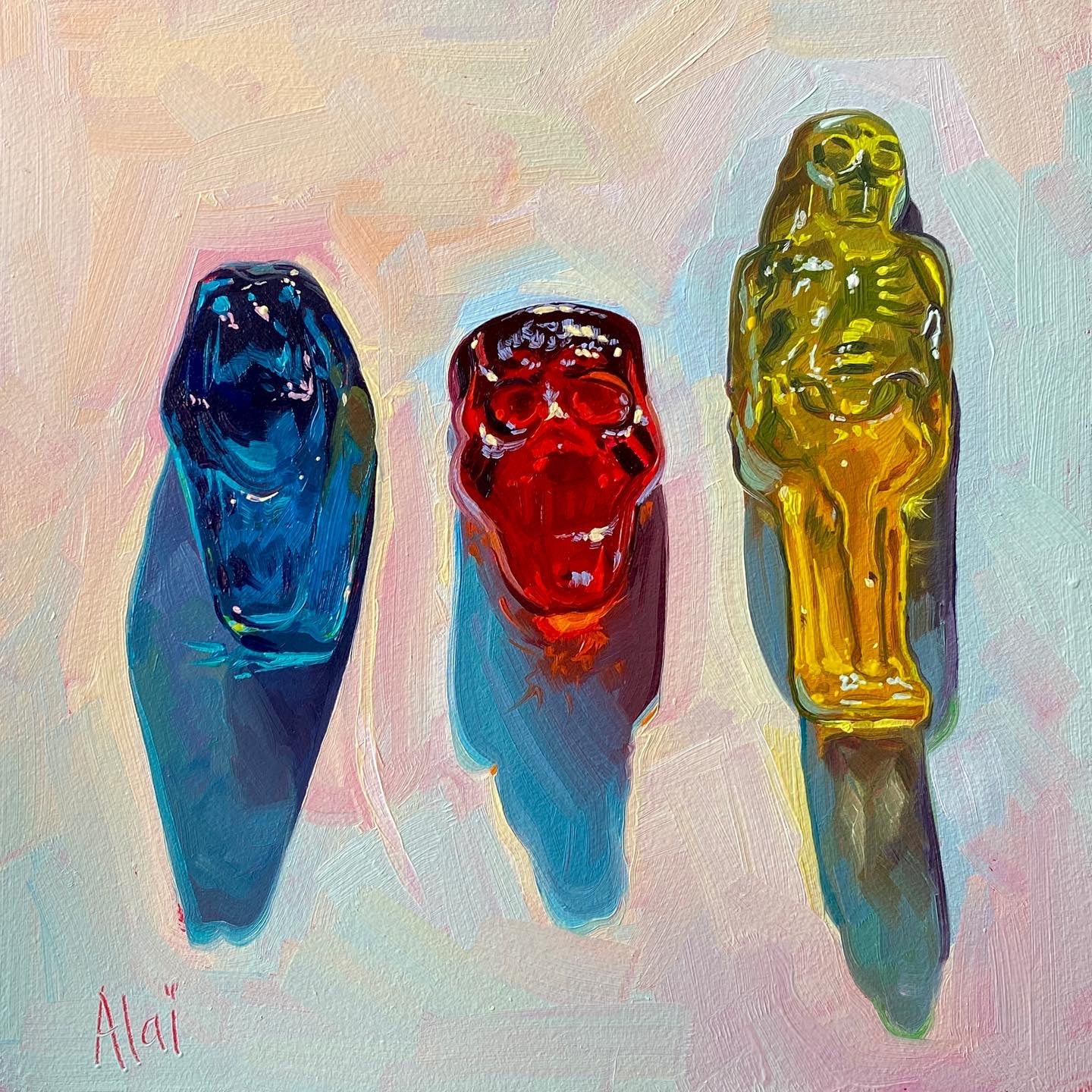 Original oil painting by Alai Ganuza titled "Spooky Gummies". Three translucent gummy candies—a blue sarcofagus, a red skull, and a yellow mummy—casting colorful shadows on a soft pastel background.