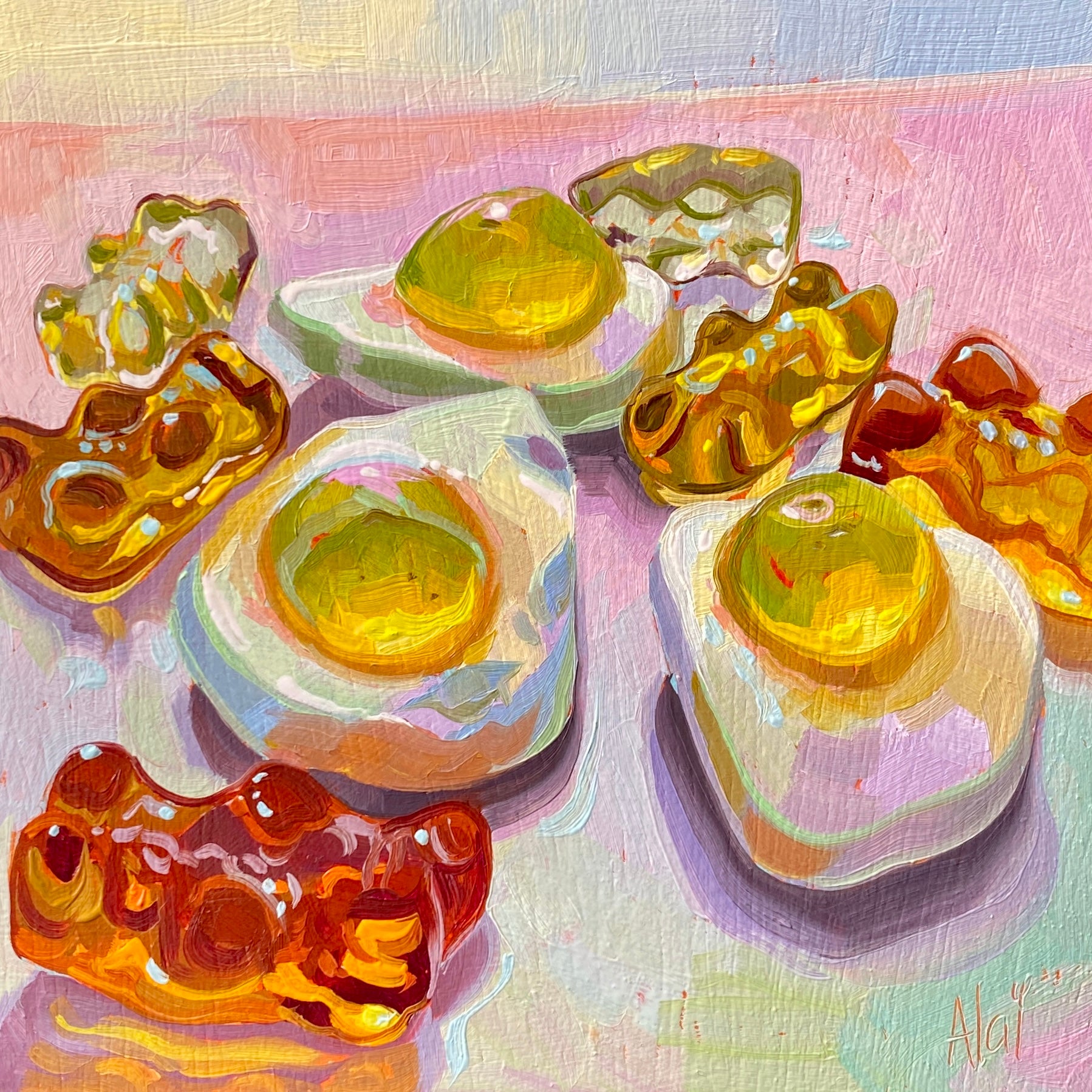 Original oil painting by Alai Ganuza titled "Golden Haribo gummies". A playful scattering of gummy fried eggs and glowing golden amber gummy bears casting soft shadows on a pastel pink and lavender background.