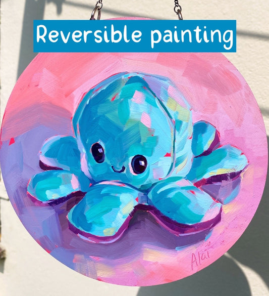 Original reversible round oil painting by Alai Ganuza titled "Blue/Violet Octoplushie". One side features a smiling light blue octopus plushie on a pink background, while the reverse depicts a grumpy purple octopus plushie on a light blue background. Both are painted on a 6.3-inch circular wood panel suspended by a metal chain.